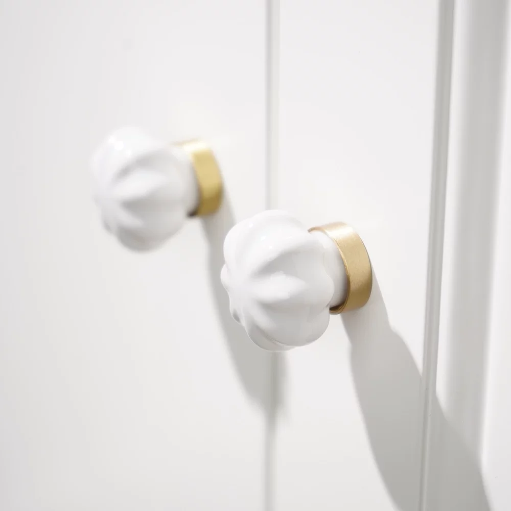 White Ceramic and Brass Handle Pull in use